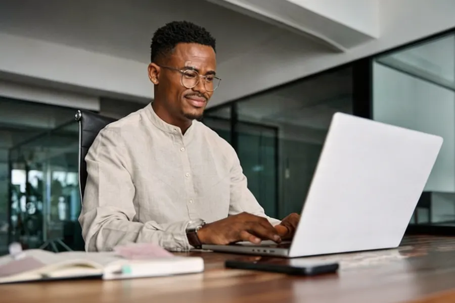 Foreign employee at a government service window presenting a work permit and residence permit for renewal